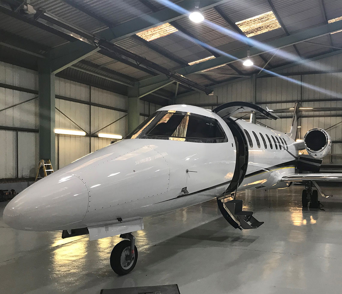 Learjet 45 private jet inside hanger