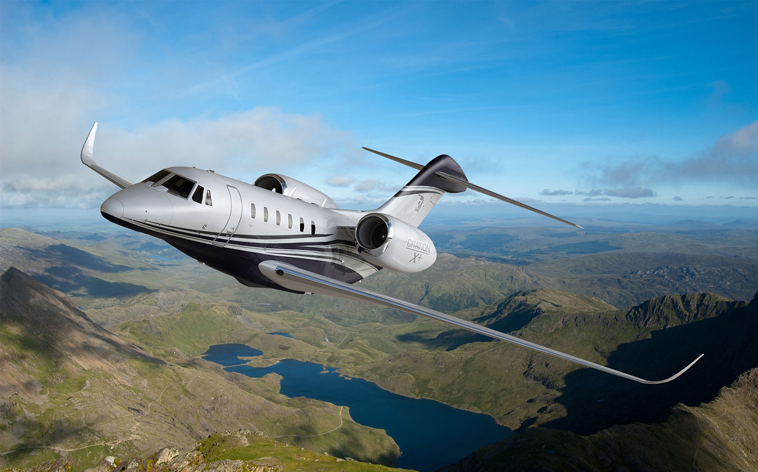 Cessna Citation X private jet charter mid flight over valley