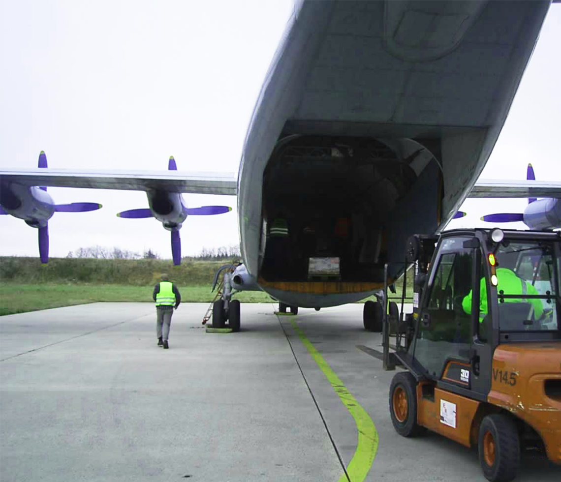Rear door loading AN-12 cargo aircraft charter crew logistics with forklift