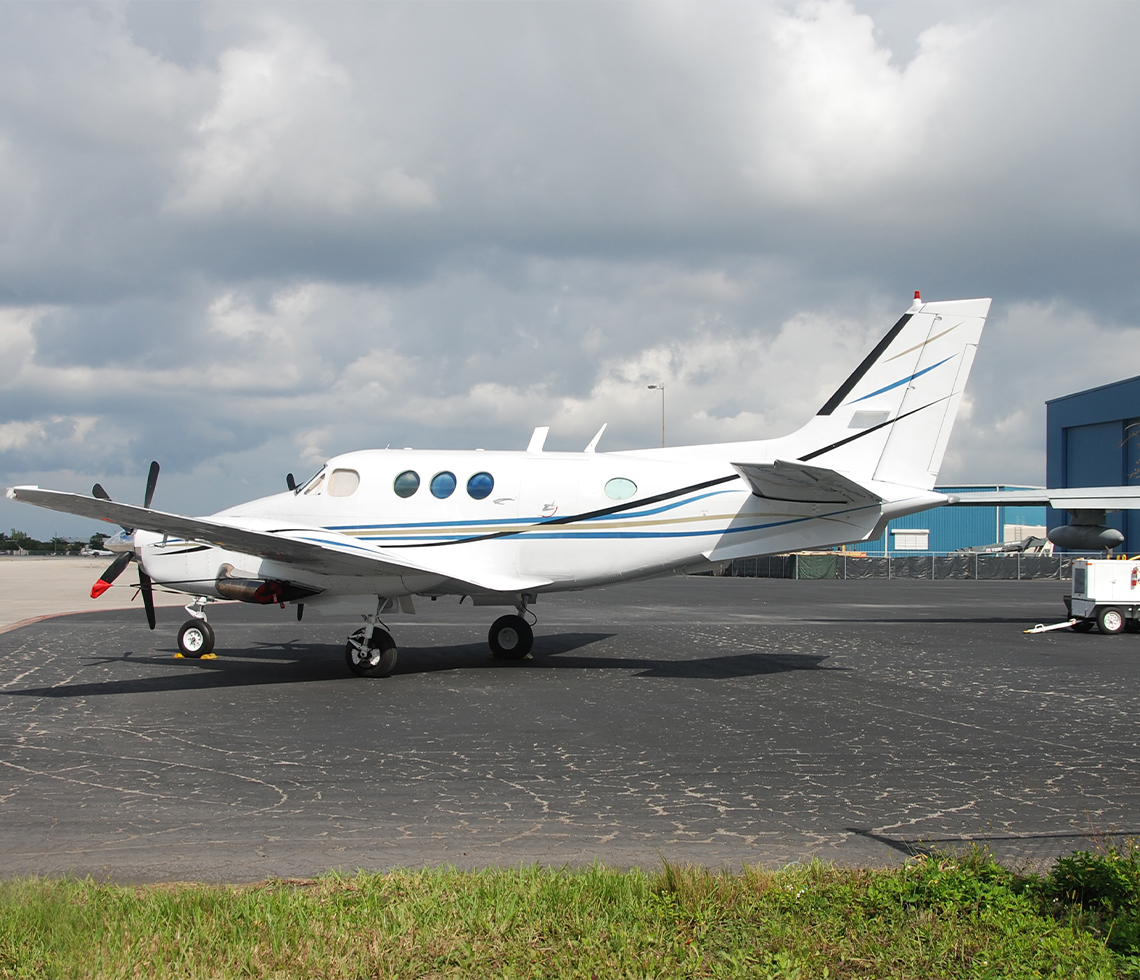 Beech King Air 90 cargo charter aircraft at airport in day