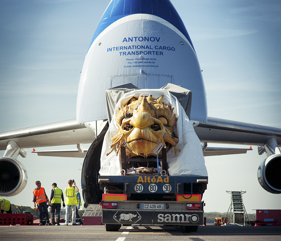 Antonov AN124 oversized cargo aircraft loading dragon sculpture freight with crew on site