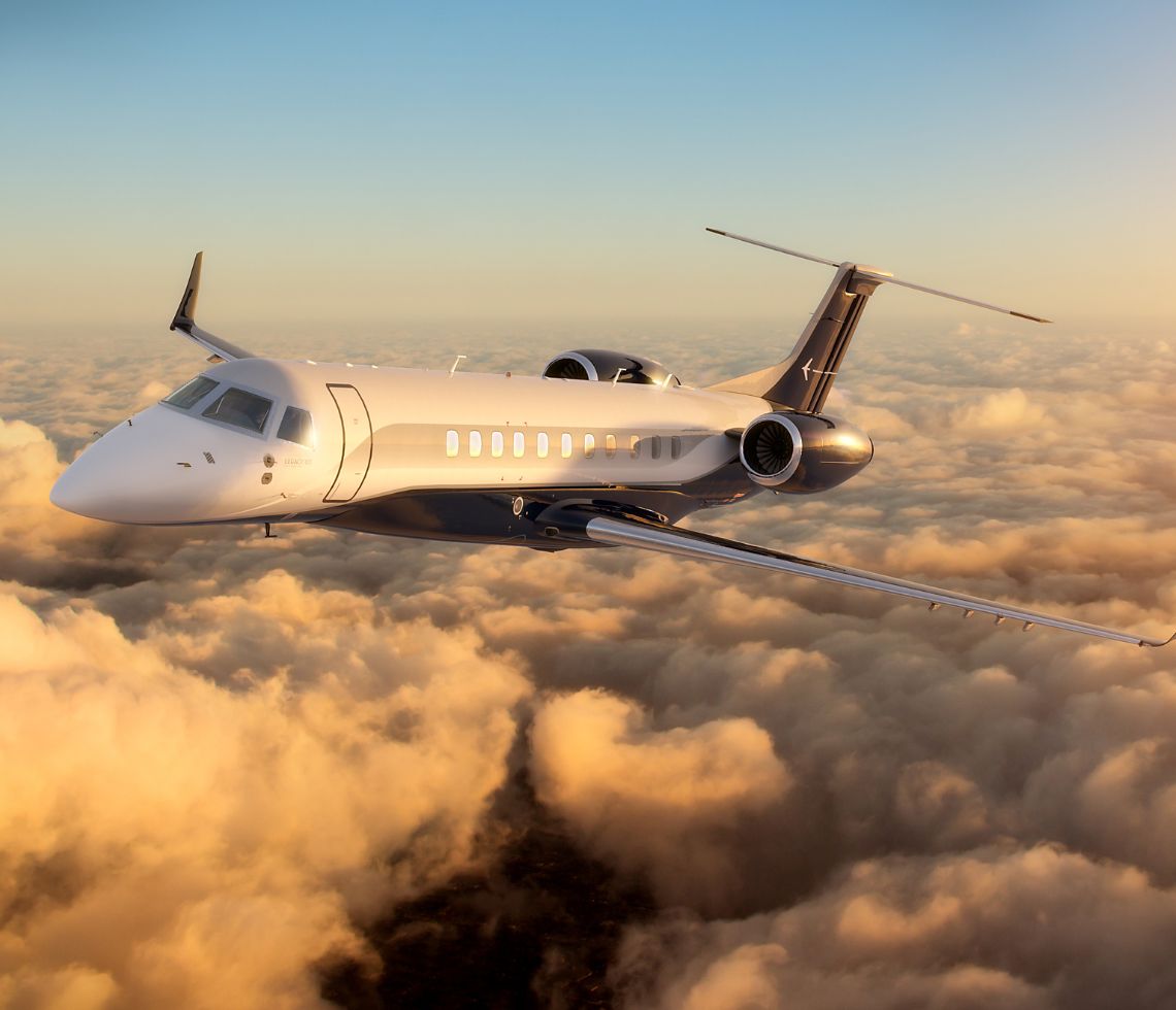 Embraer Legacy 600 private jet charter flying above clouds