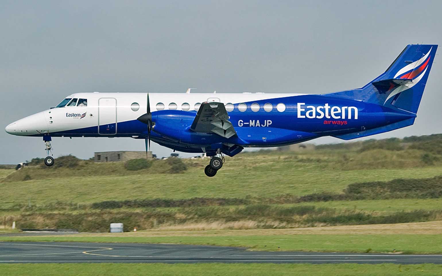 Jetstream-41 chartered private flight landing by grassy hill